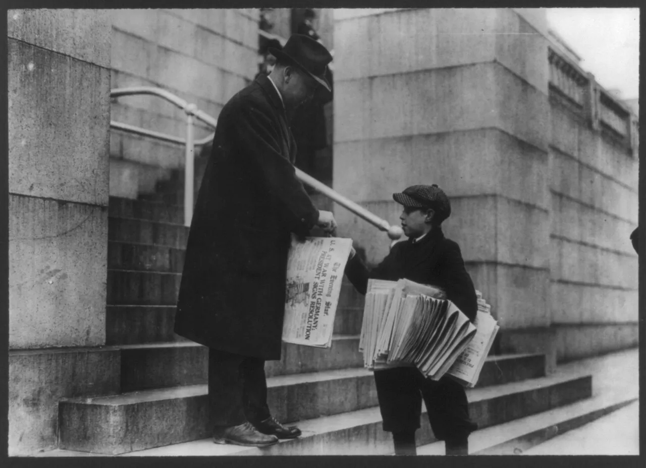 [Man buying The Evening Star from newsboy, Washington, D.C. - headline reads "U.S. at War with Germany"]